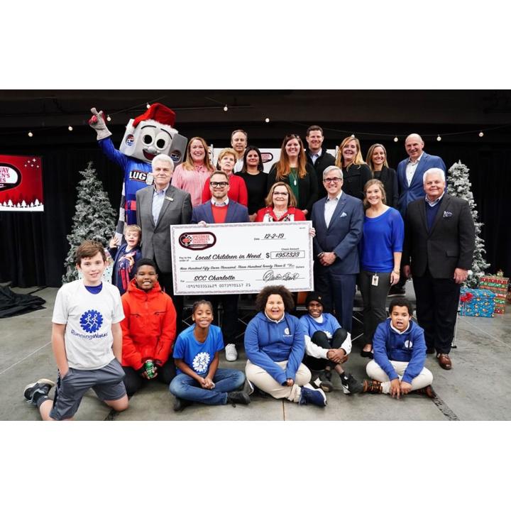 Speedway Children’s Charities Vice Chairman and Charlotte Chapter President Marcus Smith (center left) and Charlotte Chapter Director Lisa Starnes join children from area non-profits who were granted nearly $1 million during a special ceremony on Monday. 