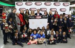 Speedway Children's Charities President Marcus Smith, center, poses with Speedway Children's Charities Charlotte chapter executives and grant recipients at a grant distribution ceremony on Wednesday at Charlotte Motor Speedway