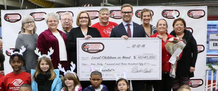 Speedway Children’s Charities Vice Chairman and Charlotte Chapter President Marcus Smith, fourth from right on the top row, poses with Speedway Children's Charities Charlotte Chapter employees and grant recipients at a special presentation on Wednesday at Charlotte Motor Speedway.