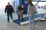 A young fan getting help from his dad at the putt-putt challenge. 