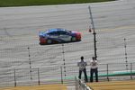 Fans looking on as pace car drives down the front stretch.