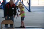 Young fan getting ready to putt. 