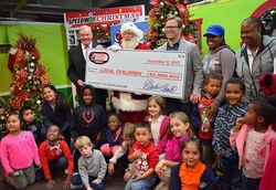 SCC announced donations of nearly $2.9 Million to help children in need. Show above with their special guests are (standing from left): Major General Chuck Swannack, Executive Director of SCC; Santa Claus; and Marcus Smith, President & CEO of Speedway Motorsports, Inc.
