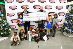 SCC announced donations of more than $3.1 Million to help children in need. Shown above with their special guests are (standing from left) Marcus Smith, President & CEO of Speedway Motorsports, Inc ., and Major General Chuck Swannack, Executive Director of SCC.